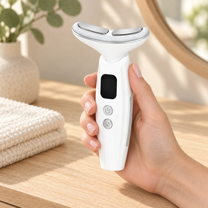 Handheld LED neck beauty device held beside a vanity