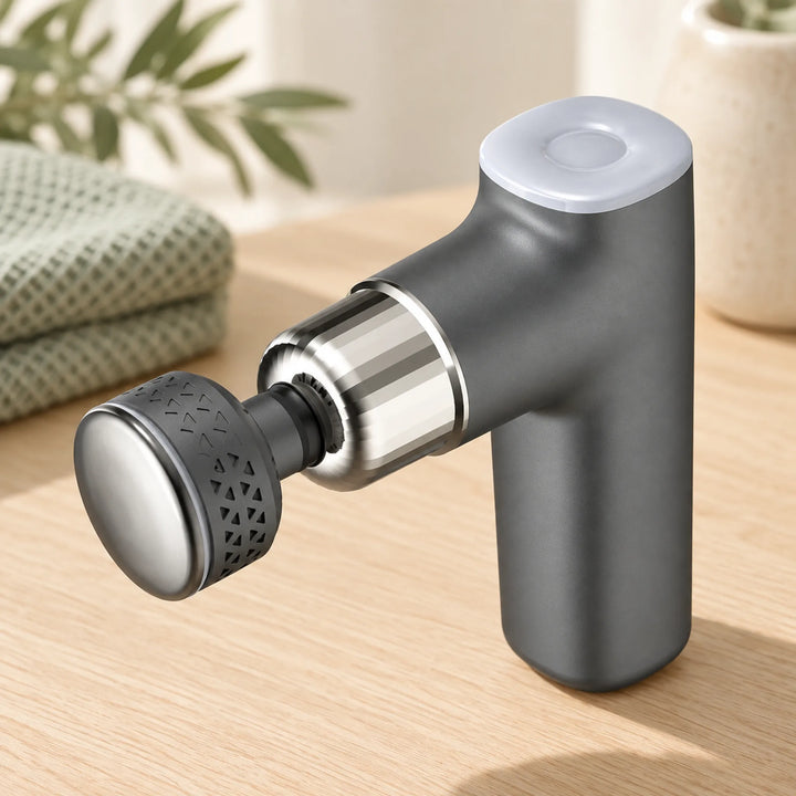 gray hot and cold massage gun with disc attachment