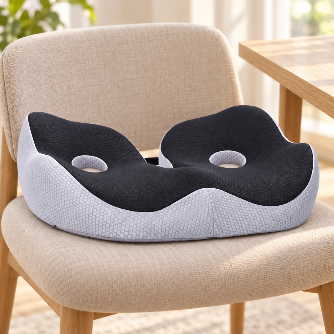 Black and light gray seat cushion with two open circular holes and a rear cutout